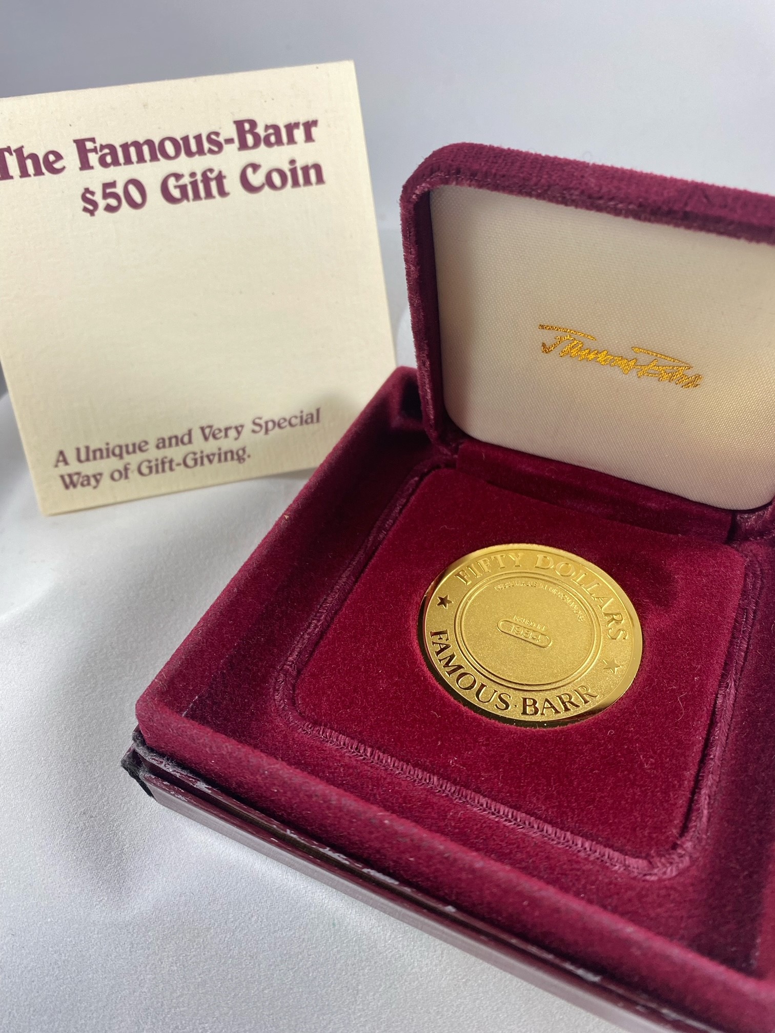 Lot 2308: Famous Barr $50 Gold Plated Gift Coin 1984